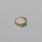 Close-up of a jade ring with green gemstone and zircon accents