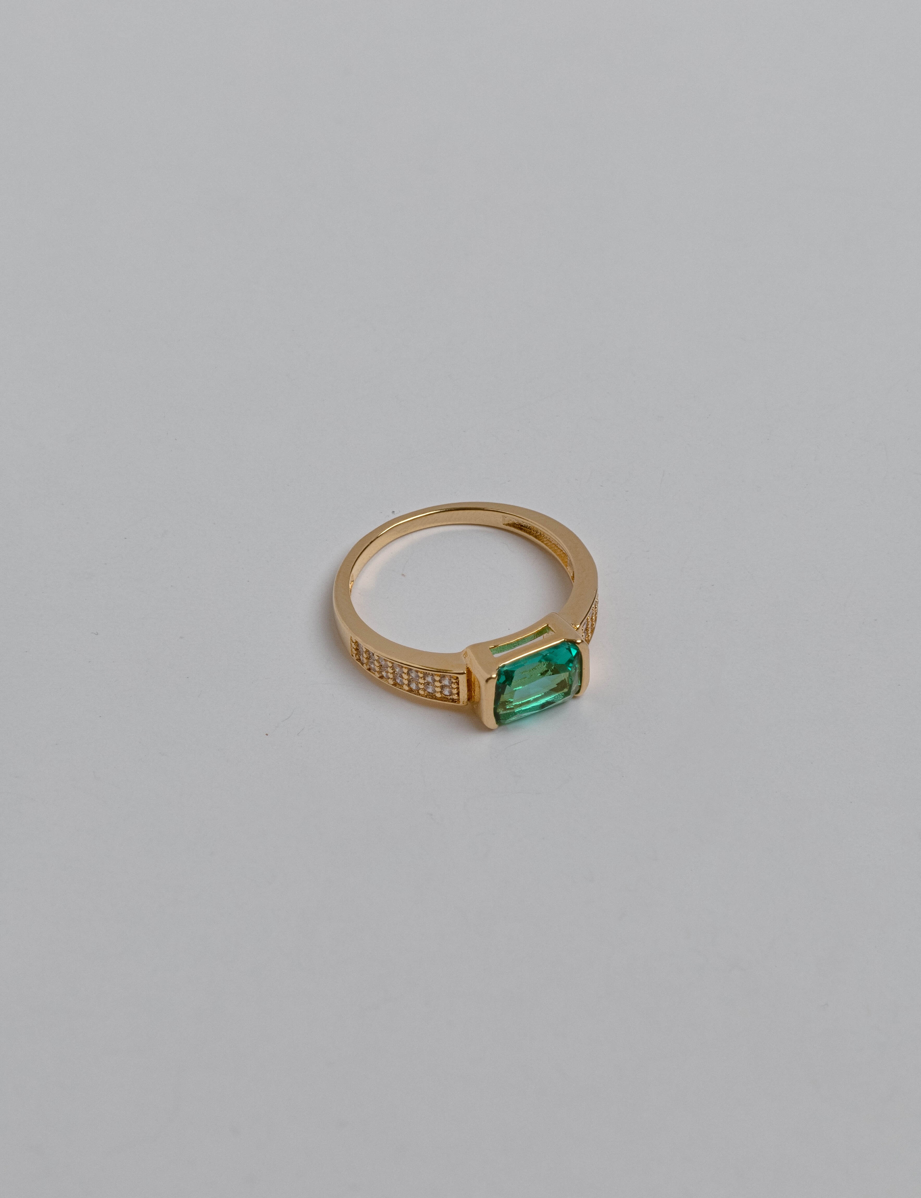 Close-up of a jade ring with green gemstone and zircon accents