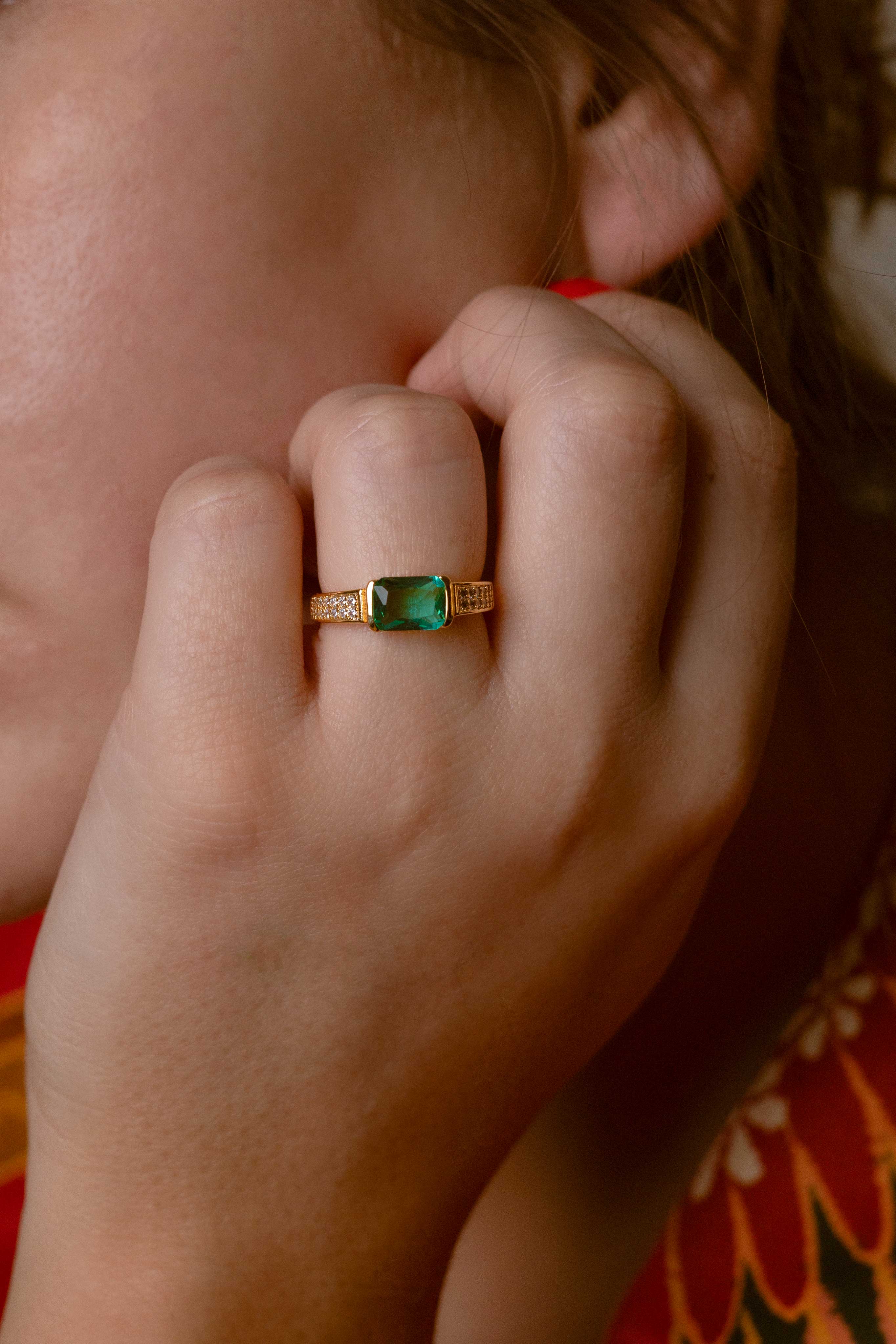 Elegant jade ring featuring a vibrant green stone and three zircon details